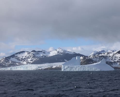 Cloud cleared to reveal mountains and glaciers. Antarctic Heritage Trust South Georgia Inspiring Explorers Expedition