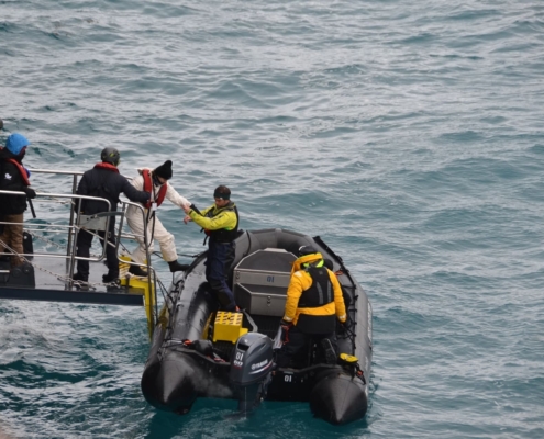 Inspiring Explorer Rose Lasham boarding a zodiac with assistance from Antarctica21 crew Antarctic Heritage Trust Inspiring Explorers Expedition South Georgia